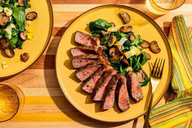 Angus Steaks With Garlic-Herb Ghee, Mushrooms, And Spinach